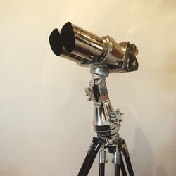 Close-up of coin-operated binoculars against white background