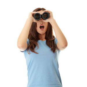 Young woman looking away against white background