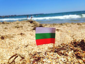 Bulgarian flag at beach against sky