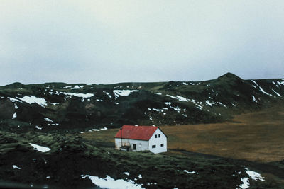High angle view of houses and mountains against clear sky