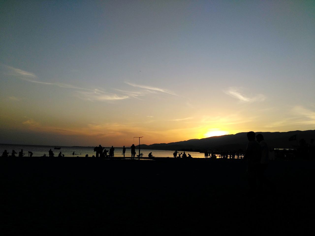 SILHOUETTE PEOPLE AT BEACH AGAINST SKY DURING SUNSET