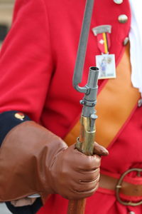 Midsection of person holding red umbrella