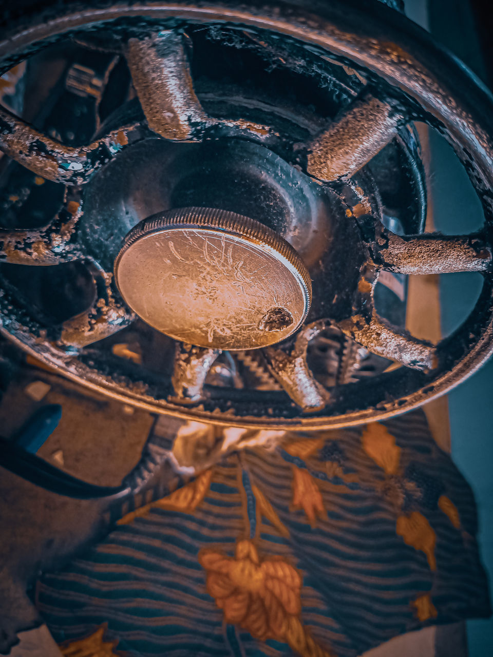 HIGH ANGLE VIEW OF RUSTY METAL HANGING ON METALLIC STRUCTURE