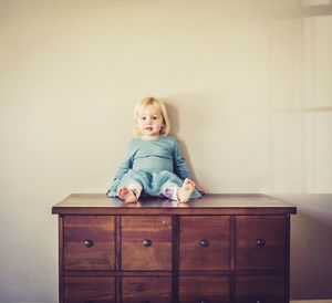 Portrait of smiling girl sitting at home