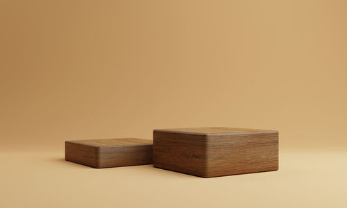 Close-up of toy on table against orange background