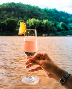 Woman holding glass of drink