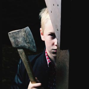 Portrait of senior man holding metal