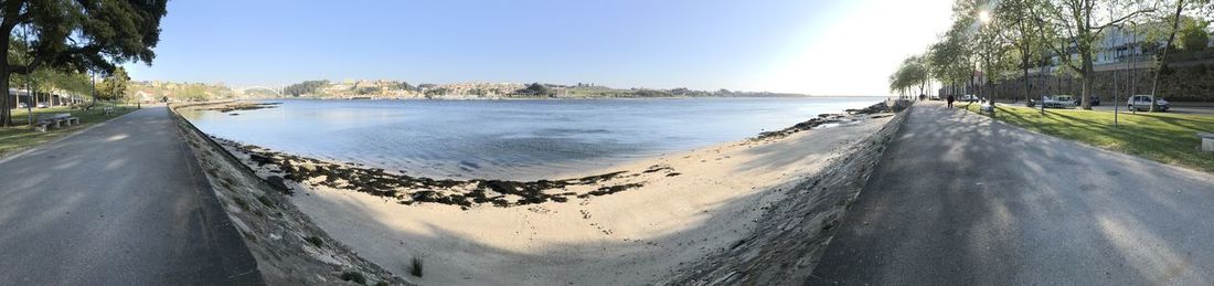 Panoramic view of road by sea against sky