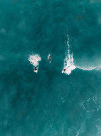 High angle view of people swimming in sea