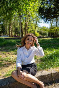 Portrait of boy sitting on field