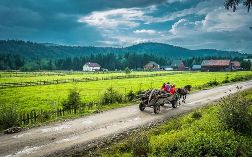 Motorcycle on agricultural landscape against sky