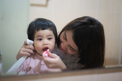 Portrait of mother and daughter at home