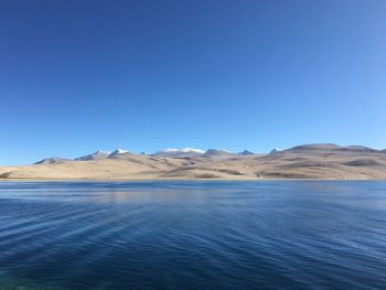 Scenic view of mountains against clear blue sky