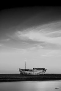 Ship moored on sea against sky