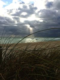 Scenic view of sea against cloudy sky