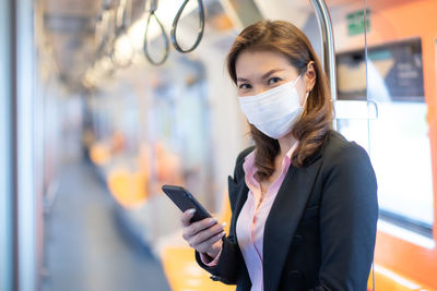 Portrait of young woman using mobile phone