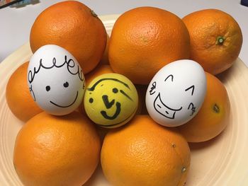 Close-up of oranges and eggs on table