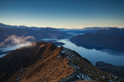 Scenic view of sea and mountains against sky