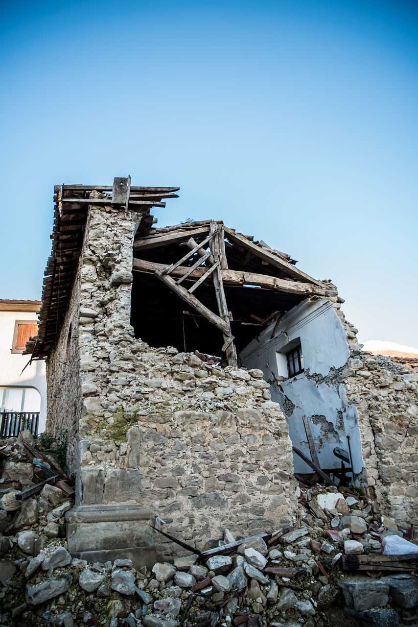 LOW ANGLE VIEW OF OLD BUILDING AGAINST BLUE SKY