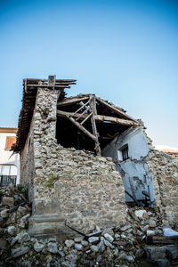 Low angle view of old building against clear blue sky