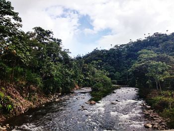 Scenic view of landscape against cloudy sky