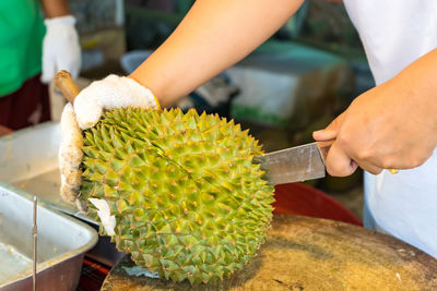 Midsection of man preparing food at market