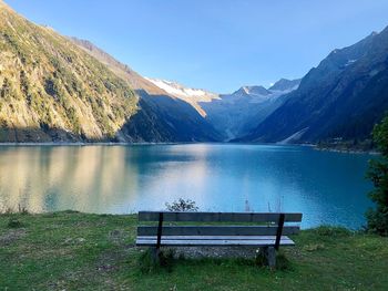 Scenic view of lake by mountains against sky