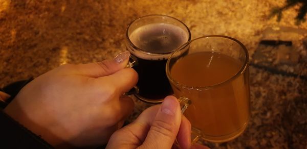 Close-up of hand holding beer glass