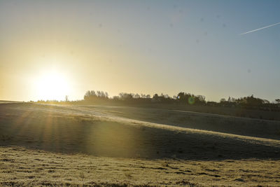 Scenic view of landscape against clear sky during sunset