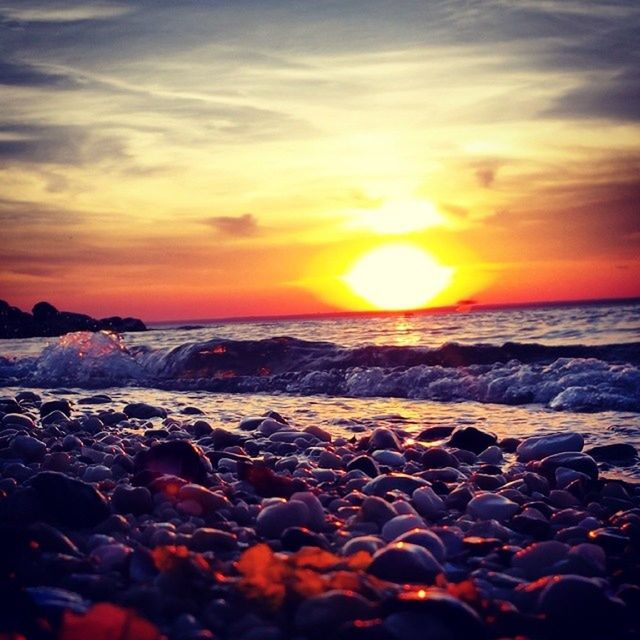 sunset, sea, beach, water, scenics, shore, orange color, horizon over water, beauty in nature, tranquil scene, sun, sky, tranquility, nature, idyllic, rock - object, wave, cloud - sky, stone - object, remote