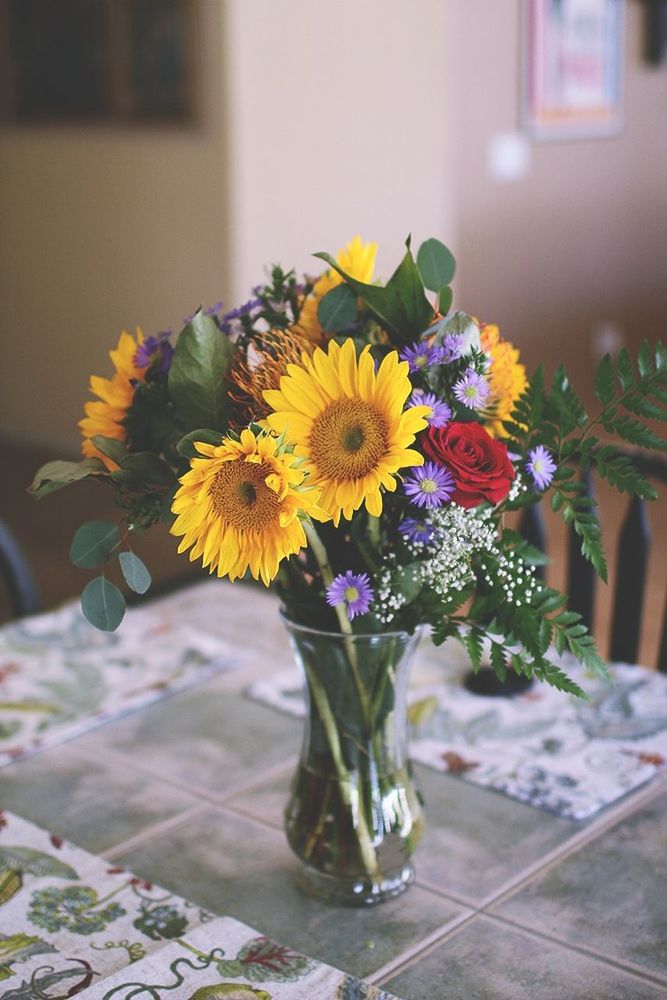 flower, indoors, freshness, petal, vase, fragility, flower head, table, potted plant, yellow, home interior, focus on foreground, beauty in nature, close-up, plant, decoration, flower arrangement, growth, flower pot, bunch of flowers