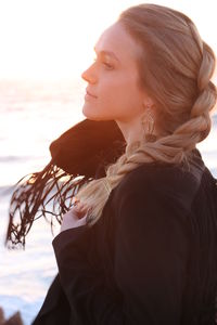 Portrait of young woman looking away outdoors