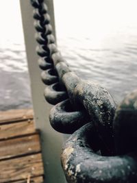 Close-up of rusty chain on pier