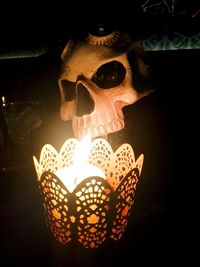 Close-up of illuminated lamp in darkroom