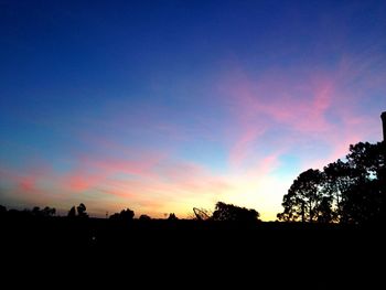 Silhouette landscape against sky at sunset