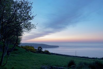 Scenic view of sea against sky at sunset