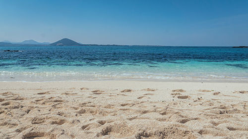 Scenic view of beach against clear sky