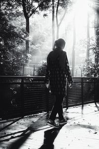 Rear view of woman walking on walkway