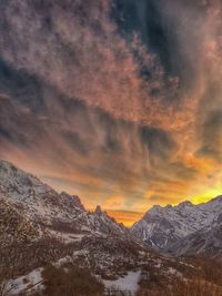 Scenic view of snowcapped mountains against sky during sunset