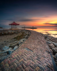 Scenic view of beach against sky during sunset