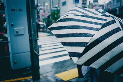 Close-up of zebra crossing on street in city