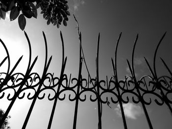 Directly below shot of metal fence against sky