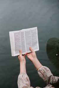 Low section of woman reading book