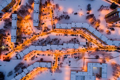 Aerial view of illuminated buildings in city during winter