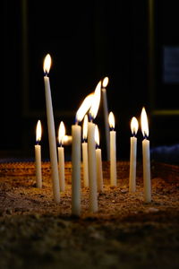 Close-up of burning candles in temple