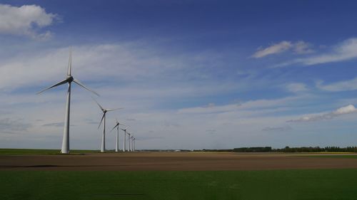 Landscape of netherlands with wind turbines in a row