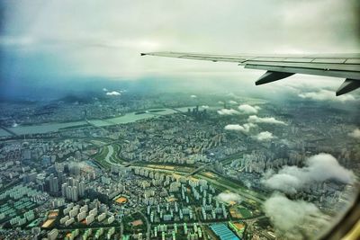 Cropped image of airplane flying over city