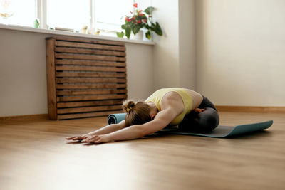 Woman exercising on floor