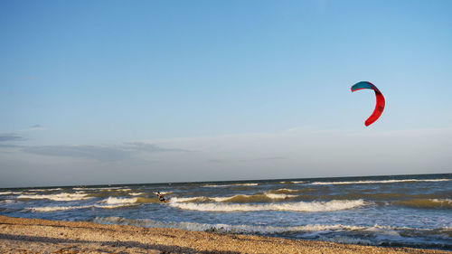 The kitesurfer conquers the sea waves