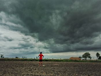 Rear view of man standing on field